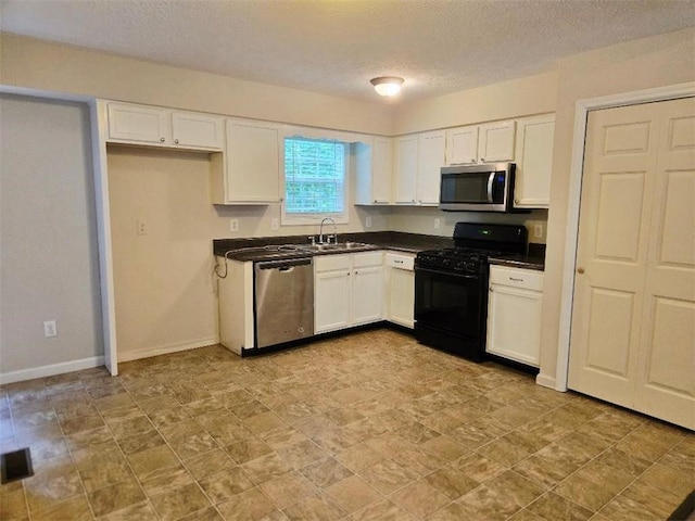 204 Twin Pines Ct, Dallas, GA 30132 - kitchen with appliances with stainless steel finishes, dark countertops, white cabinetry, and a textured ceiling