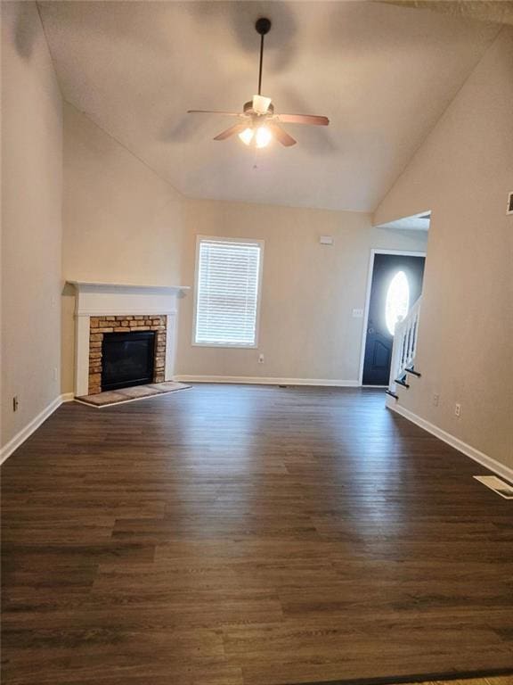 204 Twin Pines Ct, Dallas, GA 30132 - unfurnished living room with a ceiling fan, dark wood-type flooring, baseboards, a stone fireplace, and stairs