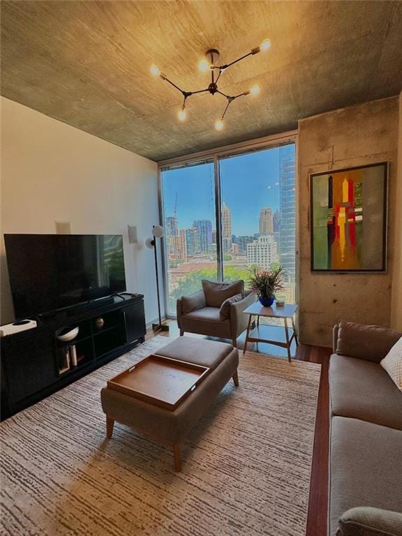 855 Peachtree St NE Unit 1406, Atlanta, GA 30308 - living room with a chandelier, wood finished floors, a wall of windows, and a view of city
