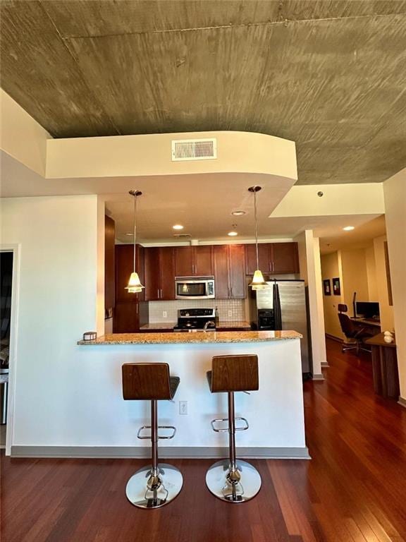 855 Peachtree St NE Unit 1406, Atlanta, GA 30308 - kitchen with stainless steel appliances, dark wood-style flooring, decorative backsplash, and pendant lighting