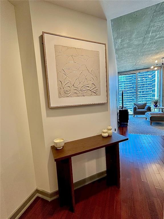 855 Peachtree St NE Unit 1406, Atlanta, GA 30308 - hall featuring dark wood-style floors and baseboards