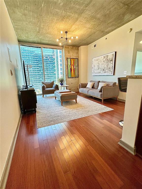 855 Peachtree St NE Unit 1406, Atlanta, GA 30308 - living area with hardwood / wood-style flooring, a chandelier, and baseboards