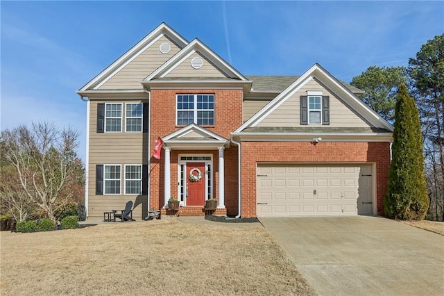 view of front of property with an attached garage, brick siding, driveway, and a front yard