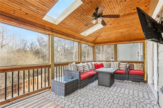 sunroom / solarium featuring an outdoor hangout area, a skylight, a wealth of natural light, and a ceiling fan