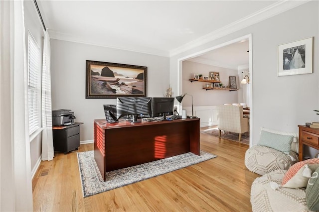 office with ornamental molding, visible vents, and wood finished floors