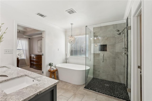 full bathroom with a stall shower, vanity, and visible vents