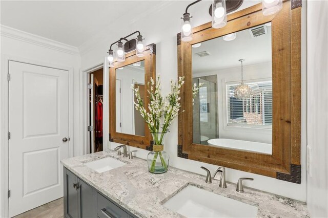 full bathroom with a shower stall, visible vents, a sink, and double vanity