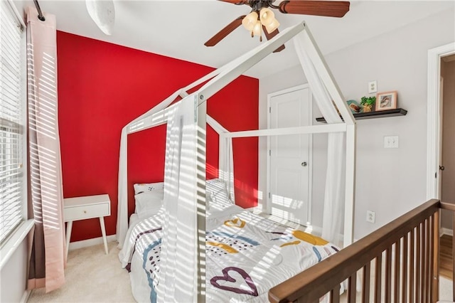 bedroom featuring a ceiling fan, baseboards, and carpet