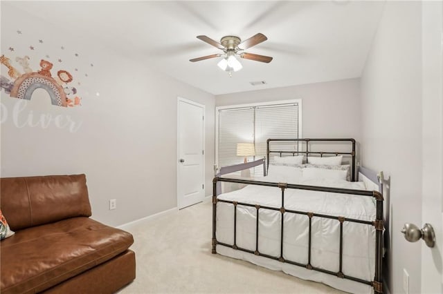 bedroom featuring baseboards, ceiling fan, visible vents, and light colored carpet