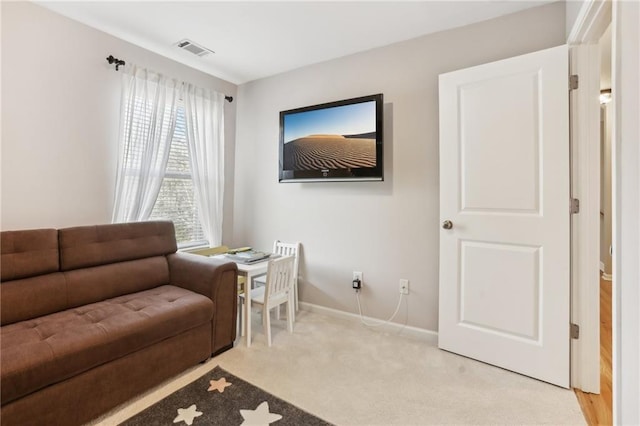 sitting room with baseboards, visible vents, and light colored carpet
