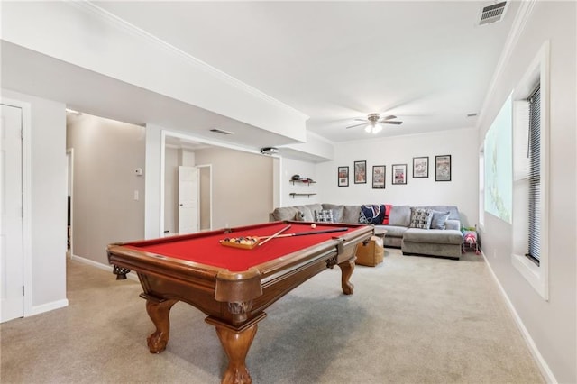 recreation room with carpet, visible vents, a ceiling fan, and ornamental molding