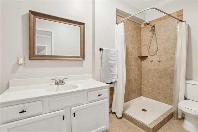 bathroom featuring toilet, tile patterned floors, vanity, and a stall shower