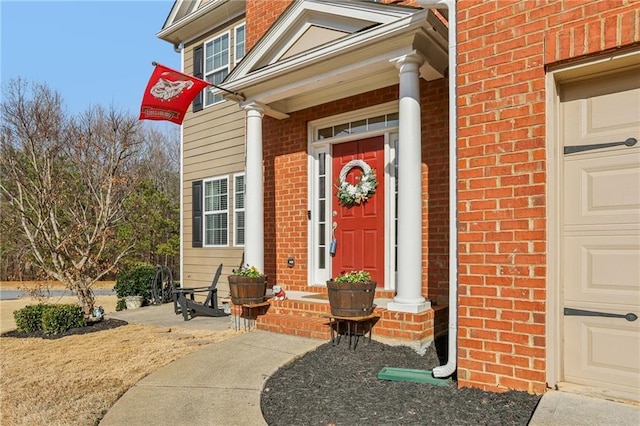 doorway to property with brick siding