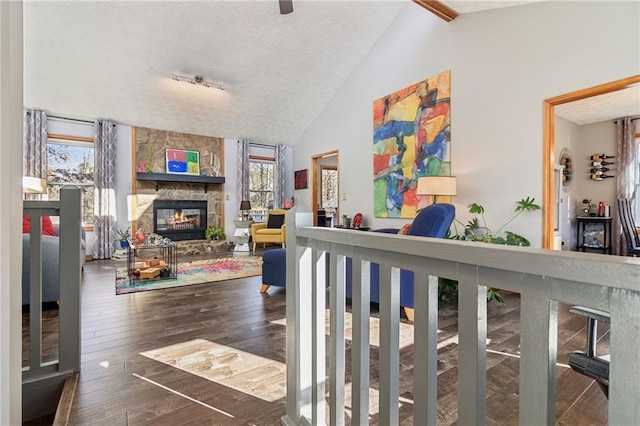 interior space with lofted ceiling, dark wood-type flooring, and a textured ceiling