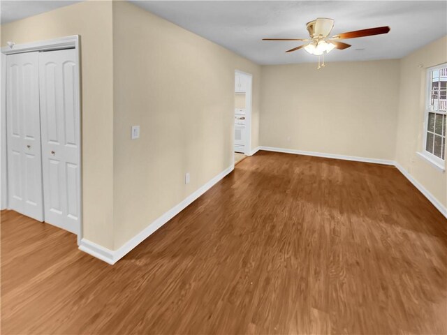 unfurnished room with ceiling fan and wood-type flooring