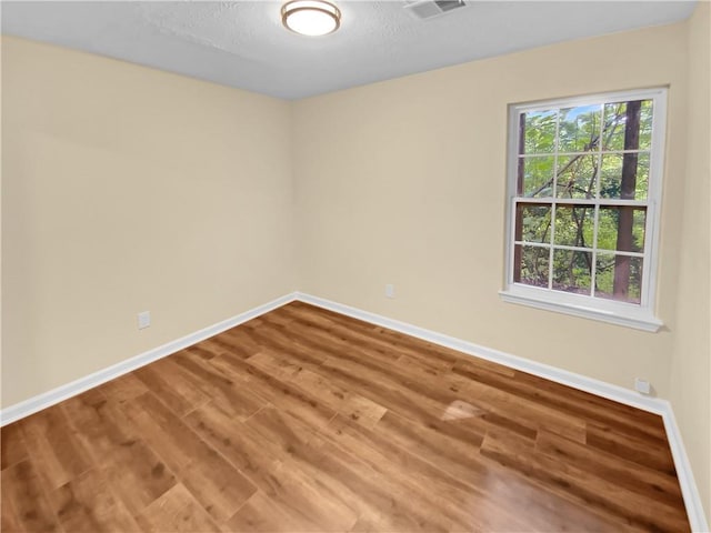 spare room with hardwood / wood-style flooring