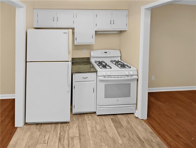 kitchen featuring white cabinets, light hardwood / wood-style flooring, and white appliances