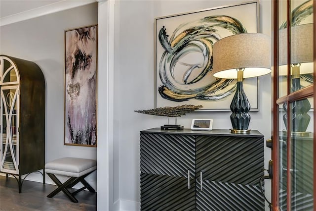interior details with arched walkways, wood finished floors, and crown molding