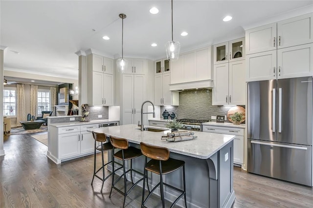 kitchen featuring range, glass insert cabinets, white cabinetry, a sink, and freestanding refrigerator