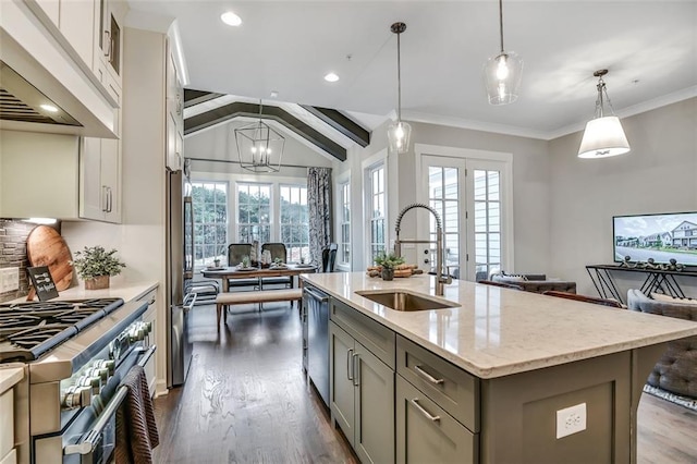 kitchen featuring light stone counters, a sink, premium range hood, gray cabinetry, and stainless steel appliances