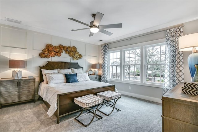bedroom featuring baseboards, visible vents, ceiling fan, and carpet