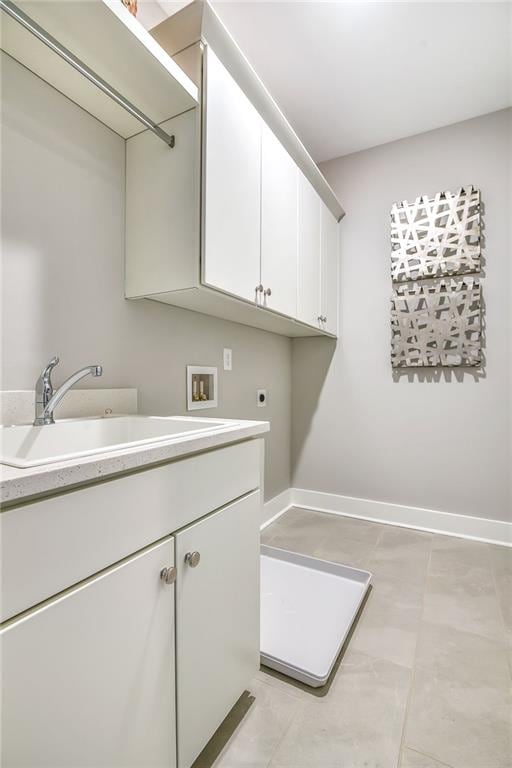 laundry area featuring hookup for a washing machine, baseboards, a sink, cabinet space, and electric dryer hookup