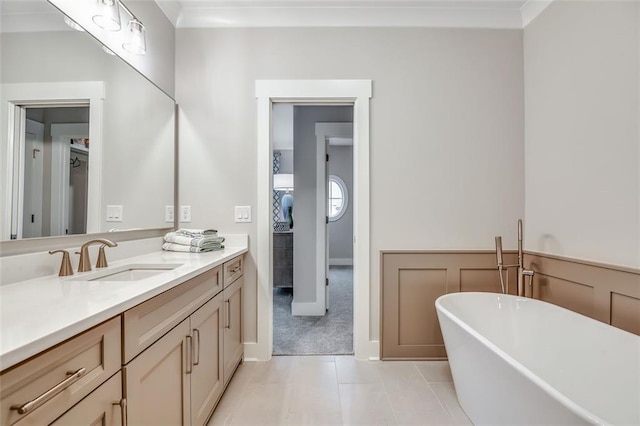 bathroom with tile patterned flooring, vanity, and a freestanding bath