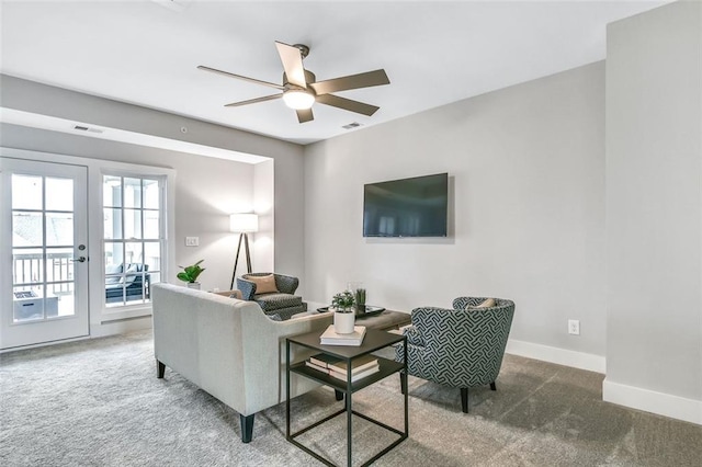 carpeted living area featuring french doors, visible vents, baseboards, and ceiling fan