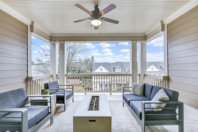 view of patio / terrace featuring ceiling fan and an outdoor living space with a fire pit