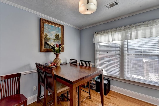 6118 Queen Anne Ct, Norcross, GA 30093 - dining area with wood finished floors, plenty of natural light, baseboards, a textured ceiling, and crown molding