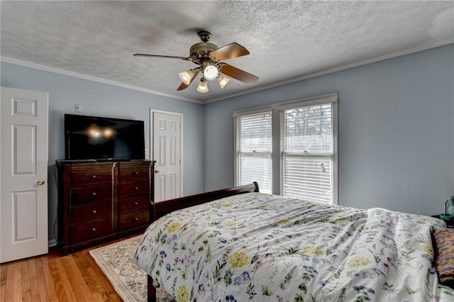 6118 Queen Anne Ct, Norcross, GA 30093 - bedroom featuring light wood-type flooring, ornamental molding, a ceiling fan, and a textured ceiling