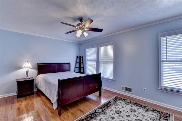 6118 Queen Anne Ct, Norcross, GA 30093 - bedroom featuring wood finished floors, multiple windows, a textured ceiling, baseboards, and ornamental molding