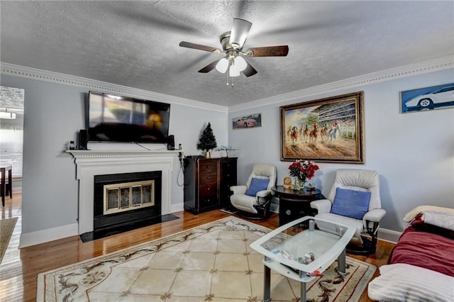 6118 Queen Anne Ct, Norcross, GA 30093 - living area with wood finished floors, a ceiling fan, a fireplace with flush hearth, crown molding, and a textured ceiling