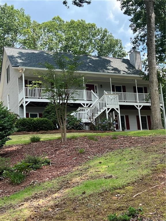 11 Seabreeze Way, Dawsonville, GA 30534 - view of front facade with a chimney, stairway, and a shingled roof