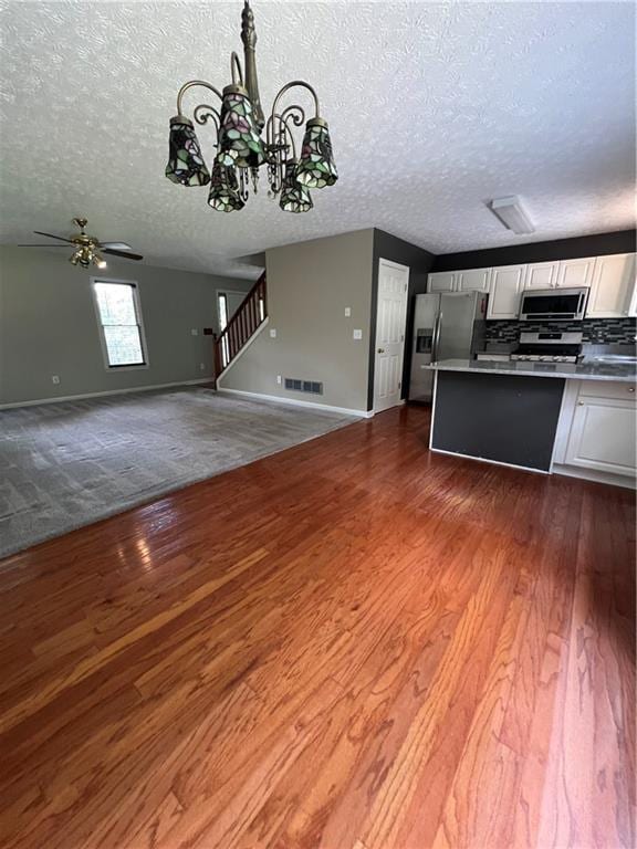 11 Seabreeze Way, Dawsonville, GA 30534 - kitchen featuring appliances with stainless steel finishes, white cabinets, a textured ceiling, dark wood-style flooring, and open floor plan