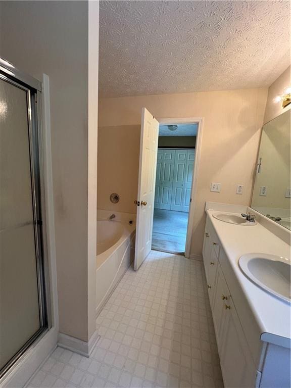 11 Seabreeze Way, Dawsonville, GA 30534 - bathroom with a garden tub, double vanity, a stall shower, a textured ceiling, and tile patterned floors