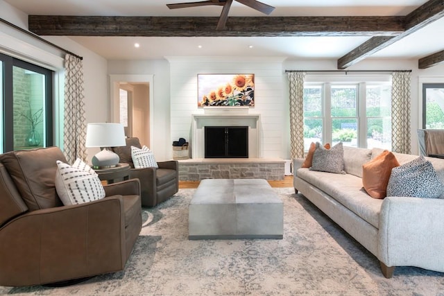 living room with a fireplace, hardwood / wood-style floors, ceiling fan, and a healthy amount of sunlight