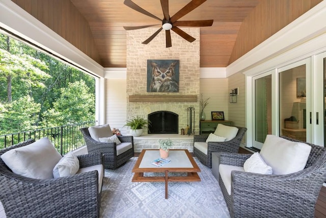 view of patio / terrace featuring an outdoor living space with a fireplace and ceiling fan