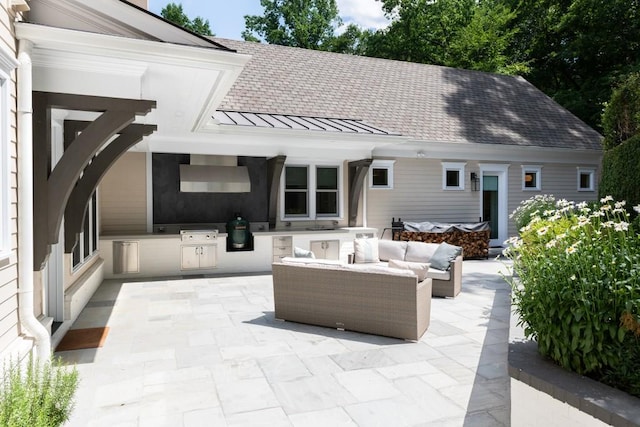 rear view of property with an outdoor kitchen, a patio area, and an outdoor hangout area