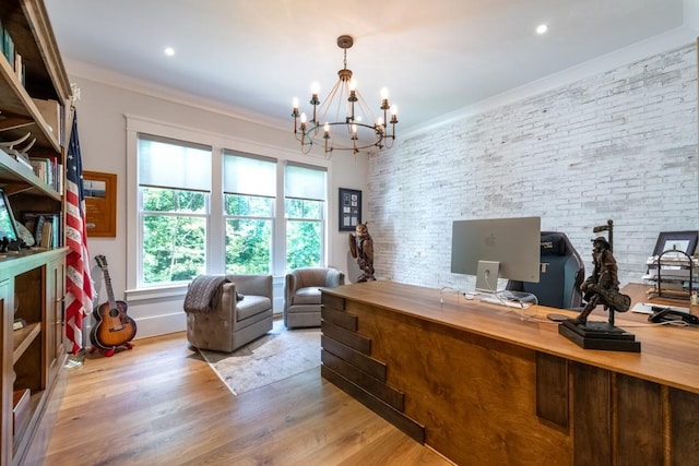 home office featuring crown molding, light hardwood / wood-style floors, brick wall, and a notable chandelier