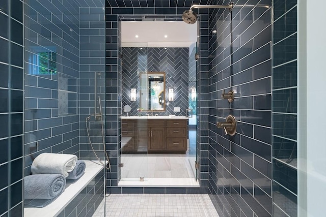 bathroom featuring plus walk in shower, vanity, tile patterned floors, and tile walls