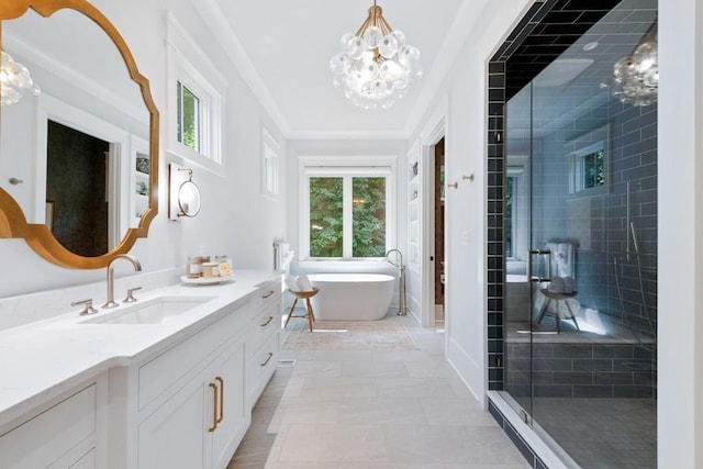 bathroom featuring separate shower and tub, a chandelier, vanity, and a healthy amount of sunlight