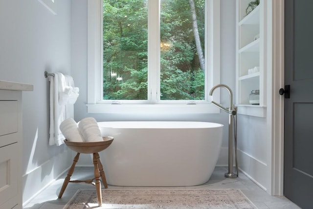 bathroom with a wealth of natural light and a washtub