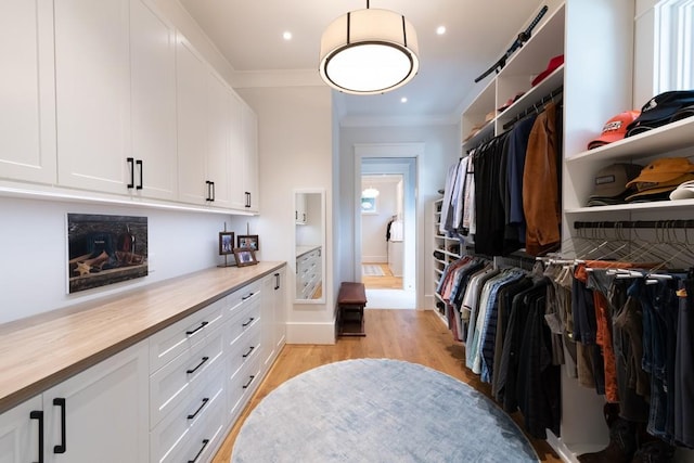 spacious closet featuring light hardwood / wood-style flooring