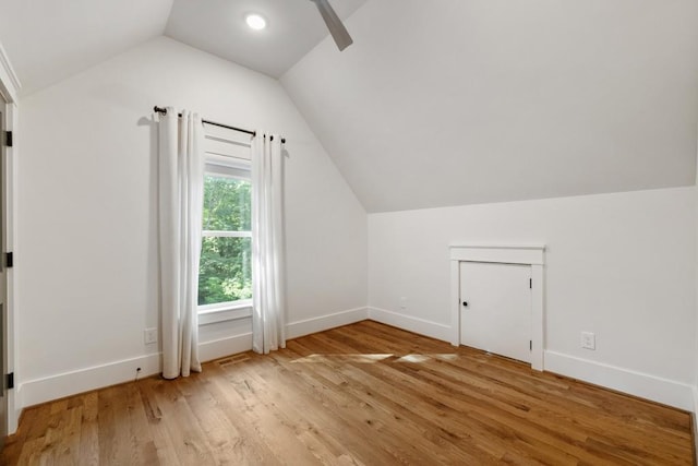 additional living space featuring hardwood / wood-style flooring and vaulted ceiling