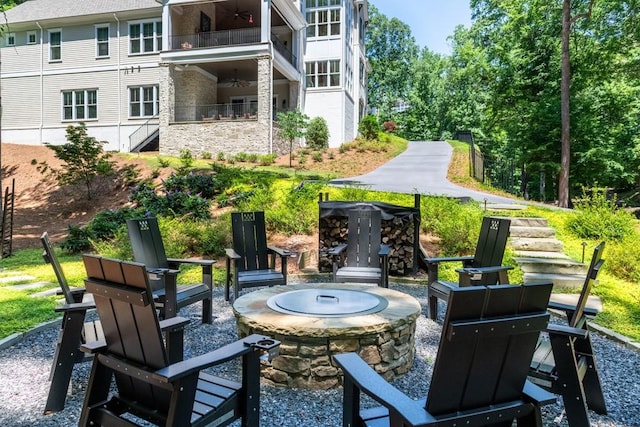 view of patio featuring a balcony and a fire pit