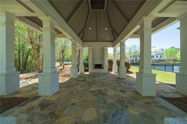 view of patio / terrace featuring a gazebo and a large fireplace