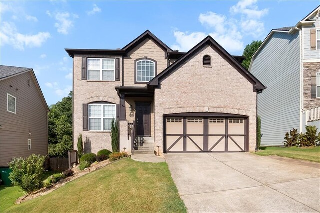 view of front of property with a front yard and a garage