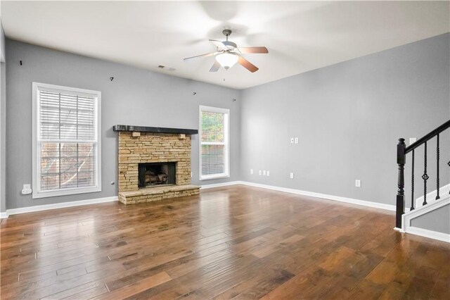 unfurnished living room with ceiling fan, a fireplace, and hardwood / wood-style floors