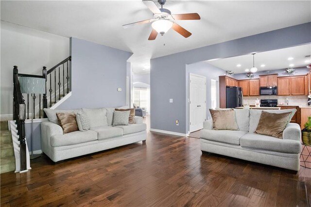 living room with ceiling fan and dark hardwood / wood-style flooring